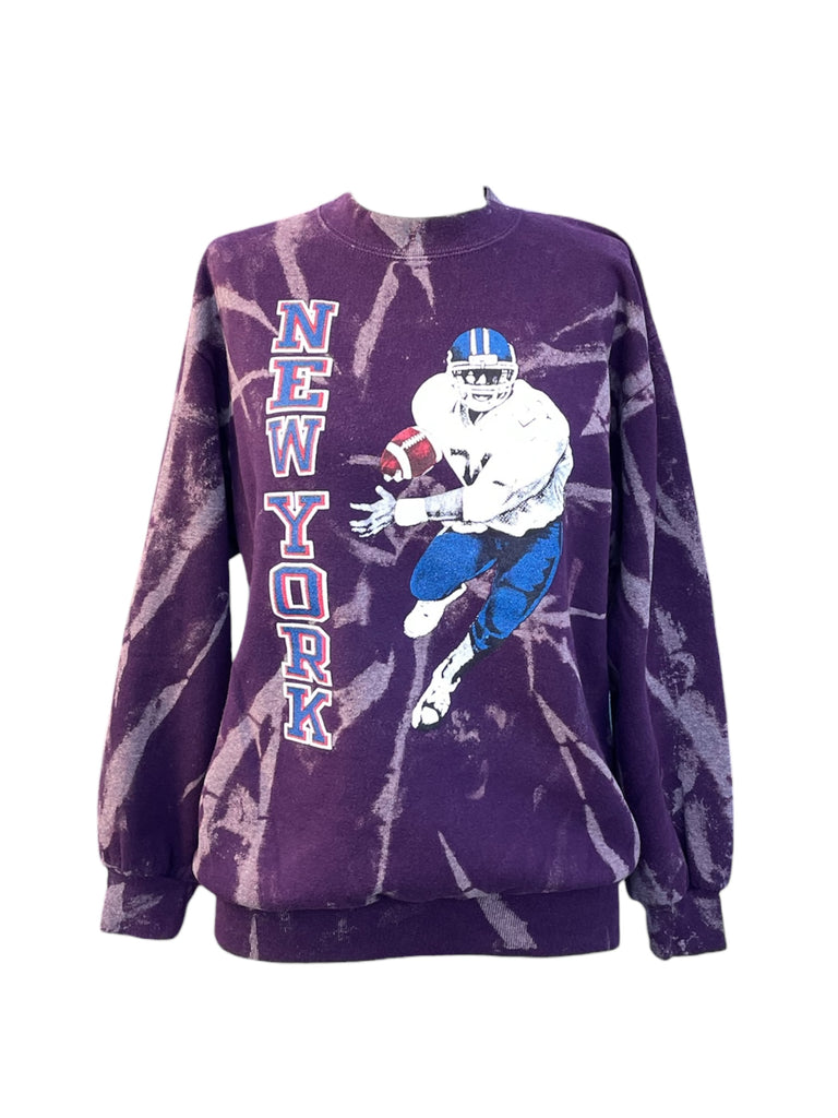 Purple tie-dye sweatshirt with football player graphic and 'New York' text on a white background