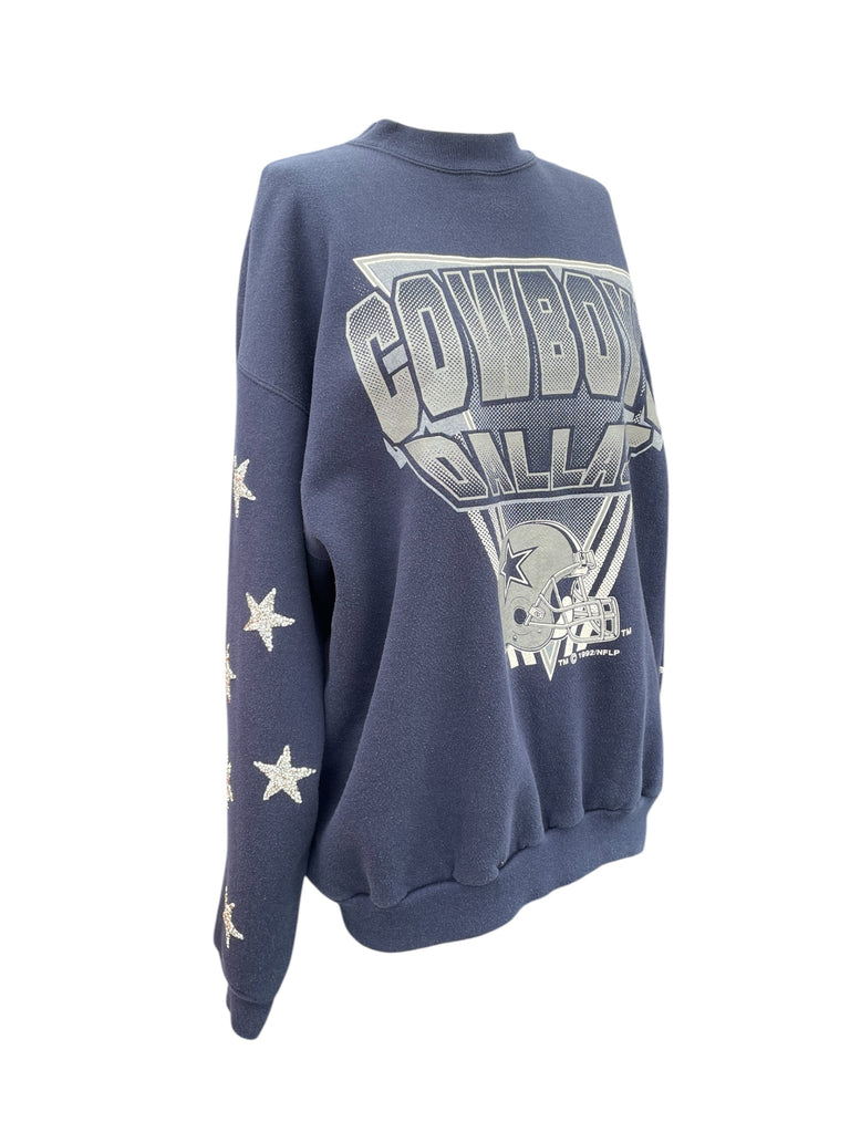 Blue sweatshirt with 'Cowboys' and star designs on a white background