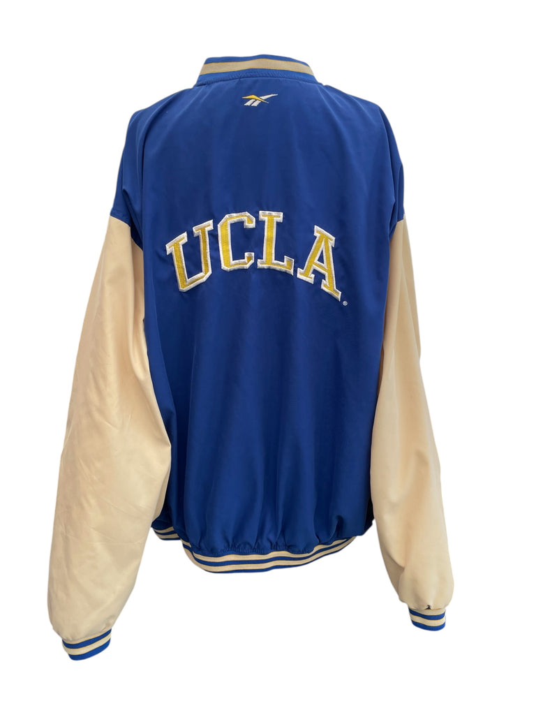 Blue and beige UCLA jacket on a white background