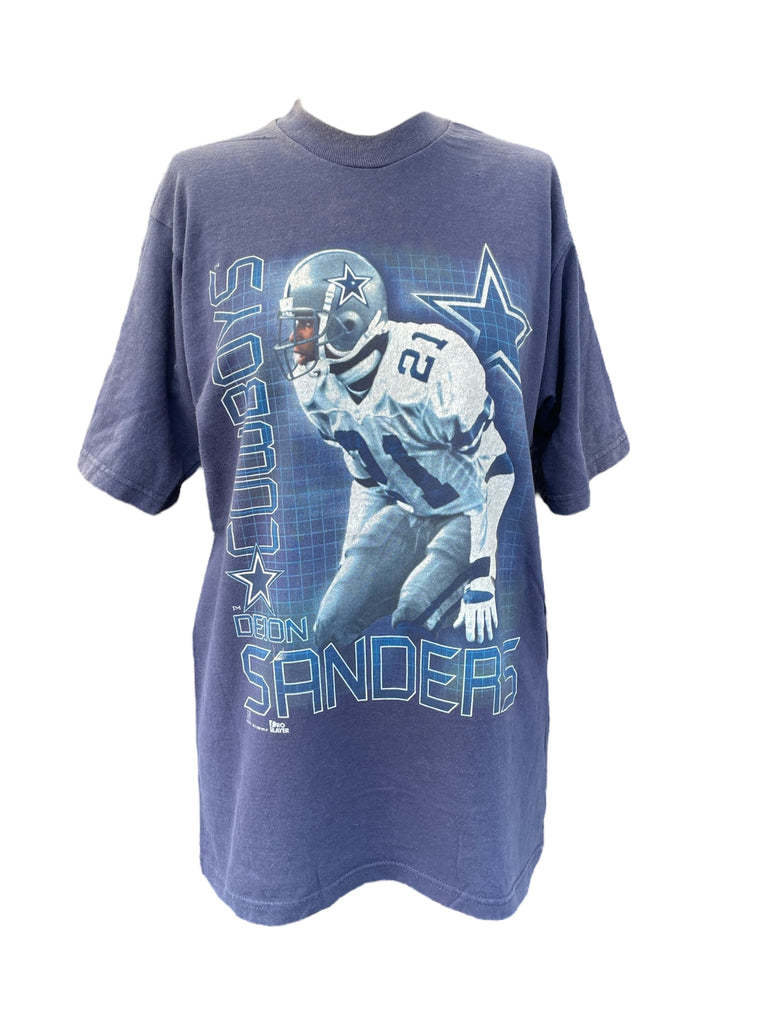 Blue t-shirt with a football player graphic and 'Cowboys' text on a white background