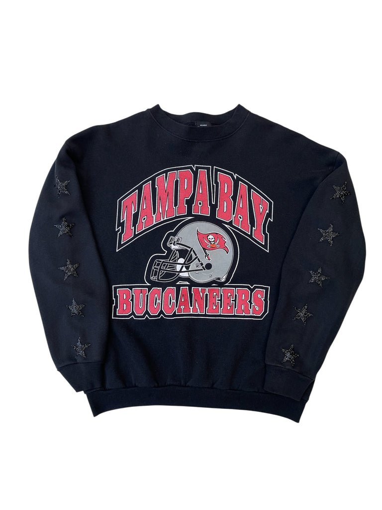 Black sweatshirt with 'Tampa Bay Buccaneers' text and logo on a white background with. black rhinestone star patches on. arms