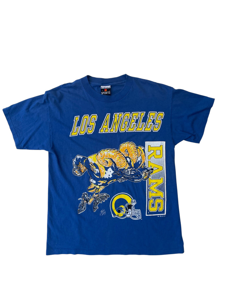 Blue t-shirt with Los Angeles Rams logo and text on a white background