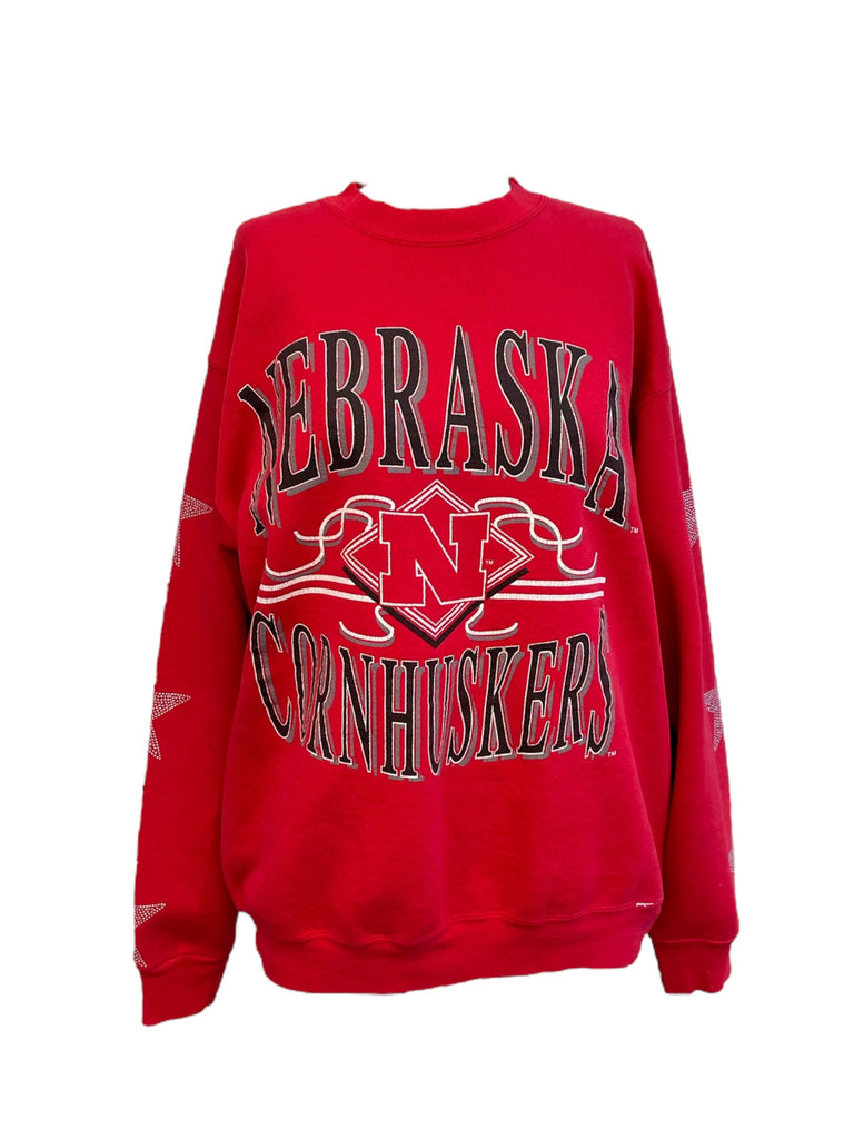 Red sweatshirt with 'Nebraska Cornhuskers' text and logo on a white background