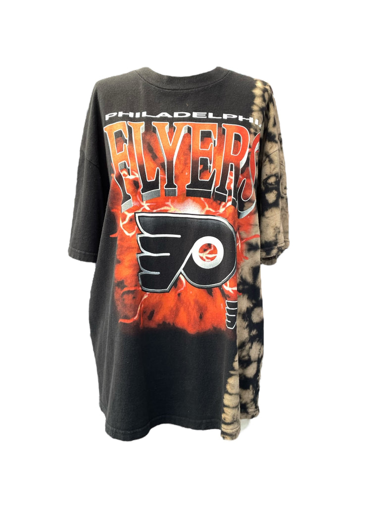Black t-shirt with tie-dye sleeves featuring the Philadelphia Flyers logo on a white background