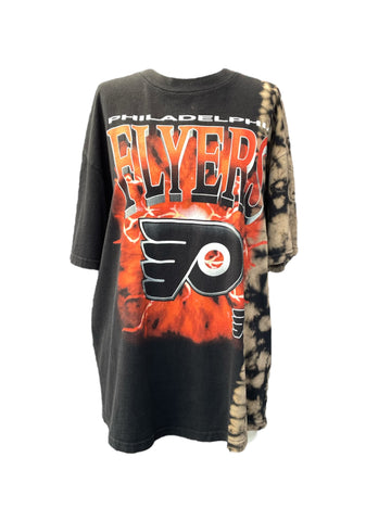 Black t-shirt with tie-dye sleeves featuring the Philadelphia Flyers logo on a white background
