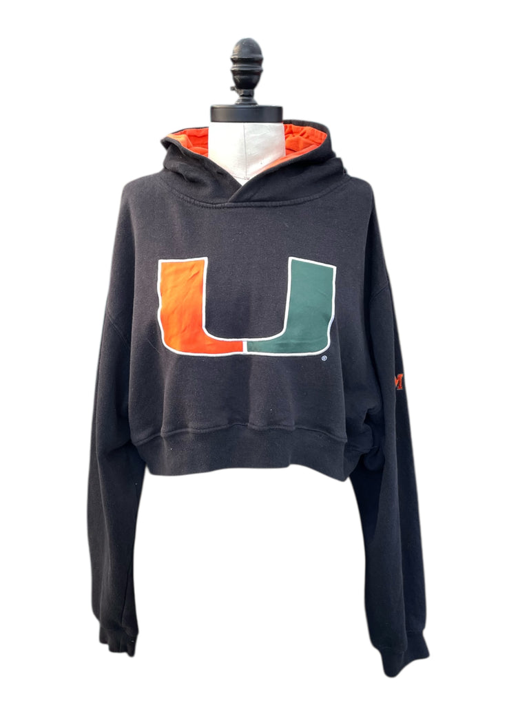 Black hoodie with a logo on a mannequin against a white background