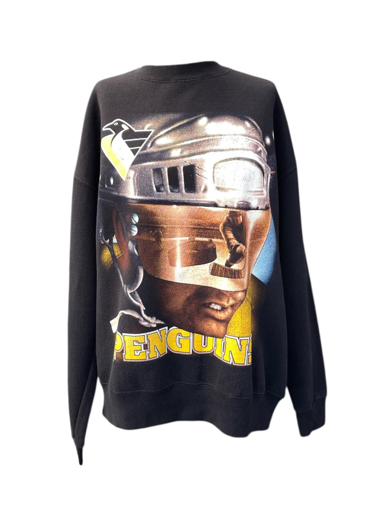 Black sweatshirt with a graphic of a person wearing a helmet and goggles, with 'PENGUIN' text, on a white background.