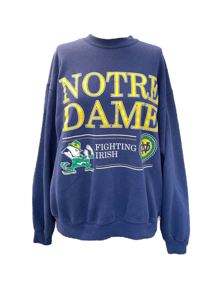 Blue sweatshirt with 'Notre Dame Fighting Irish' text and logos on a white background