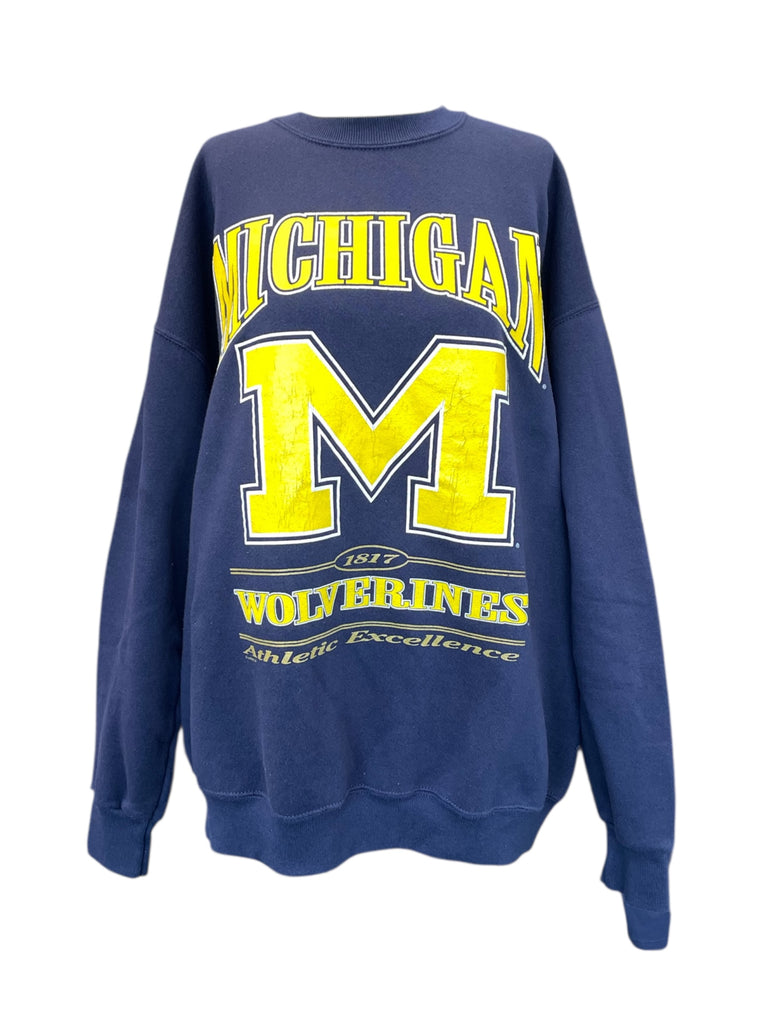 Blue sweatshirt with yellow 'M' and text on a white background